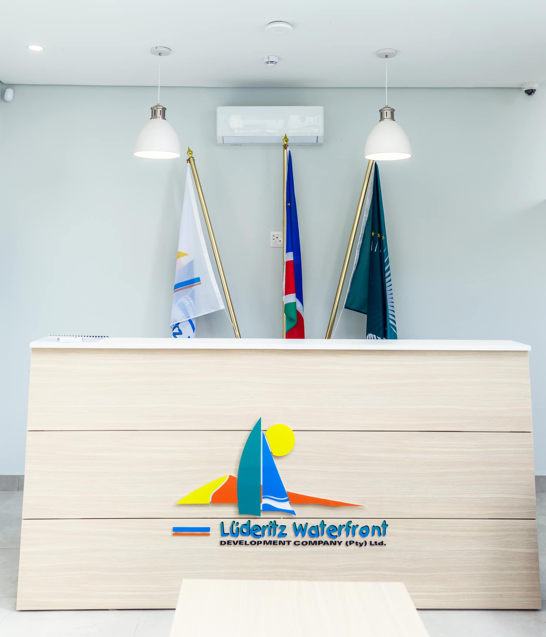 L&uuml;deritz Waterfront reception desk lit by two pendant fittings