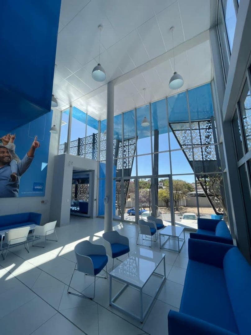 Double-height MTC reception area in daylight, with pendant lighting and glazed frontage